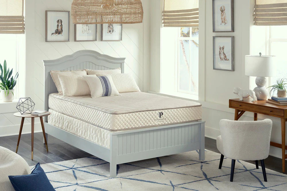 Mattress on a bed in a bedroom setting with decor elements.