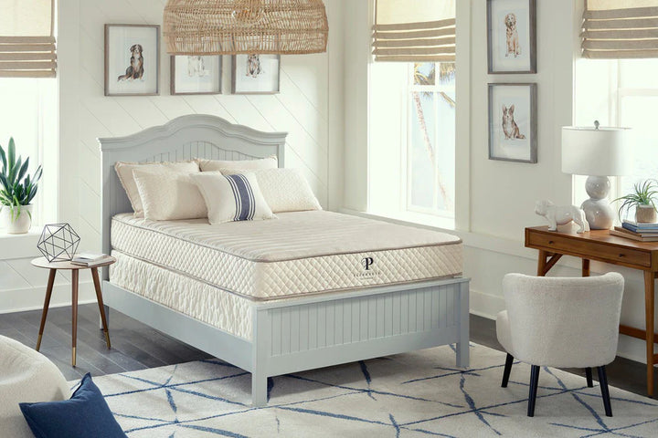 Mattress on a bed in a bedroom setting with decor elements.
